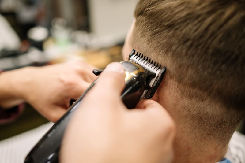 close up view man getting haircut